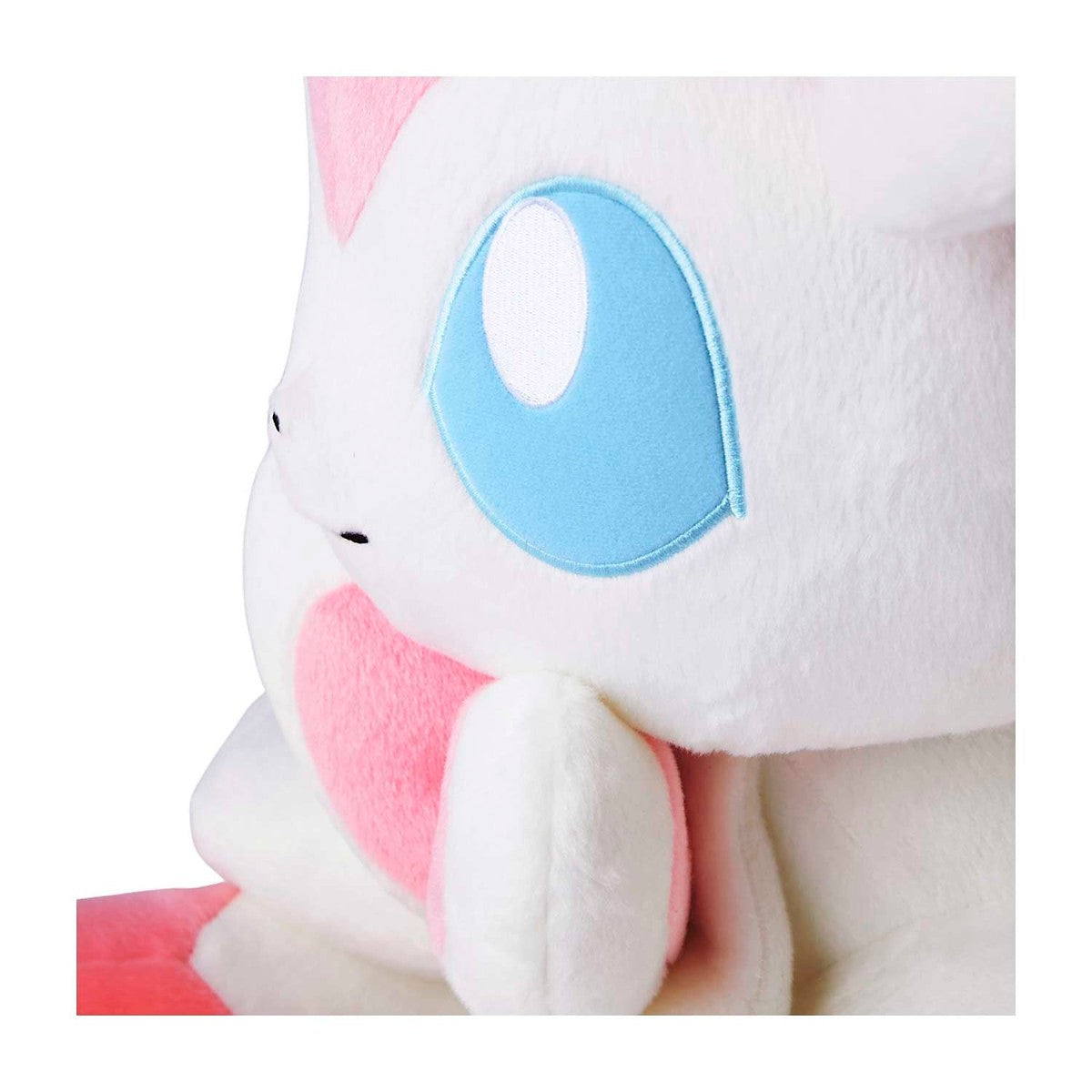 Close-up of a plush toy with a pink and white design on a white background