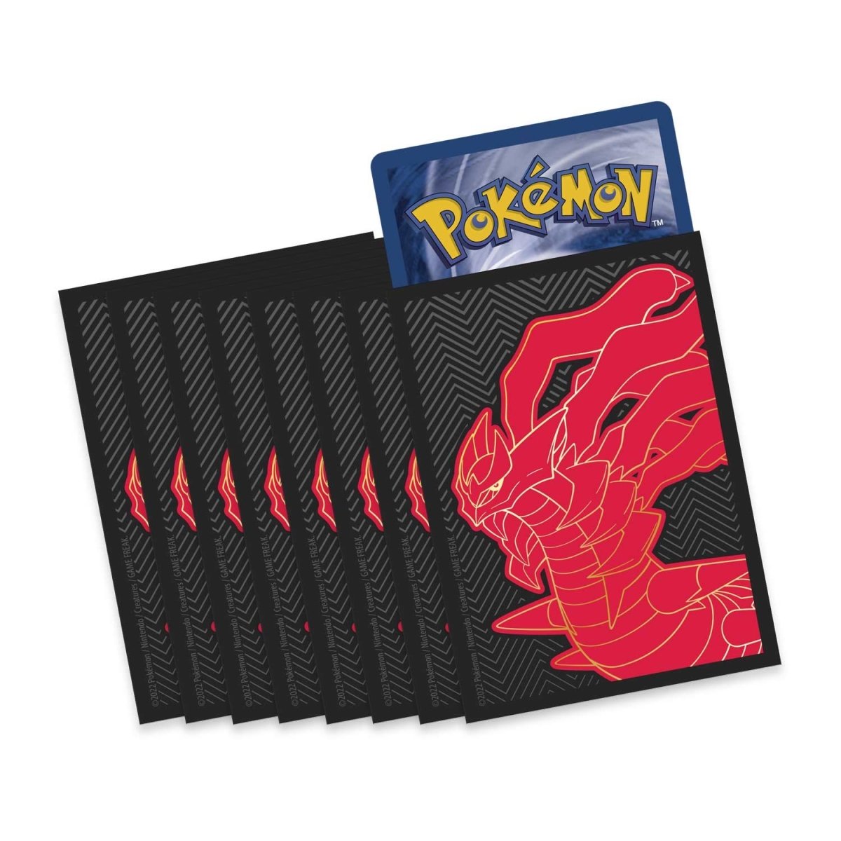 Pokémon trading card with a red dragon design on a black card, surrounded by additional black cards.