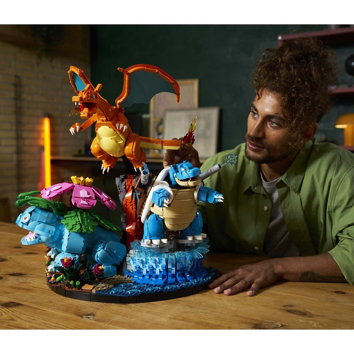 Man interacting with a colorful toy set on a wooden table